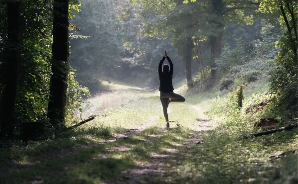 Frau in Yoga-Pose in der Natur